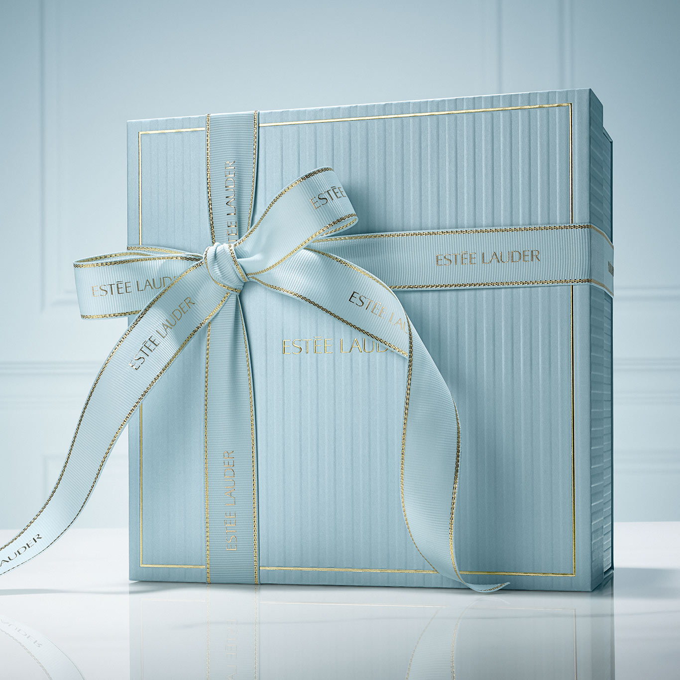 Big light blue box with blue ribbon with a plain light blue background