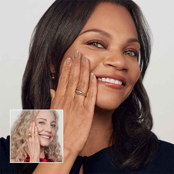 An image of two women having their makeup applied