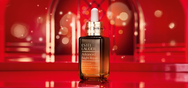 Advanced Night Repair Serum bottle on red holiday background